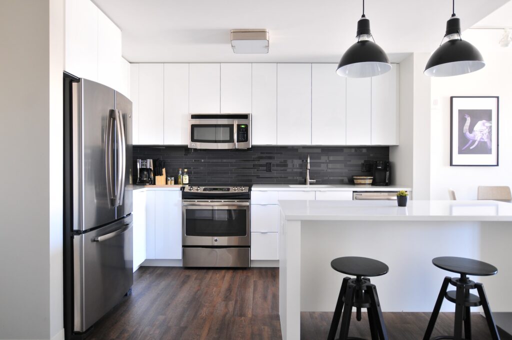 A high spec kitchen and dining space in black and white design